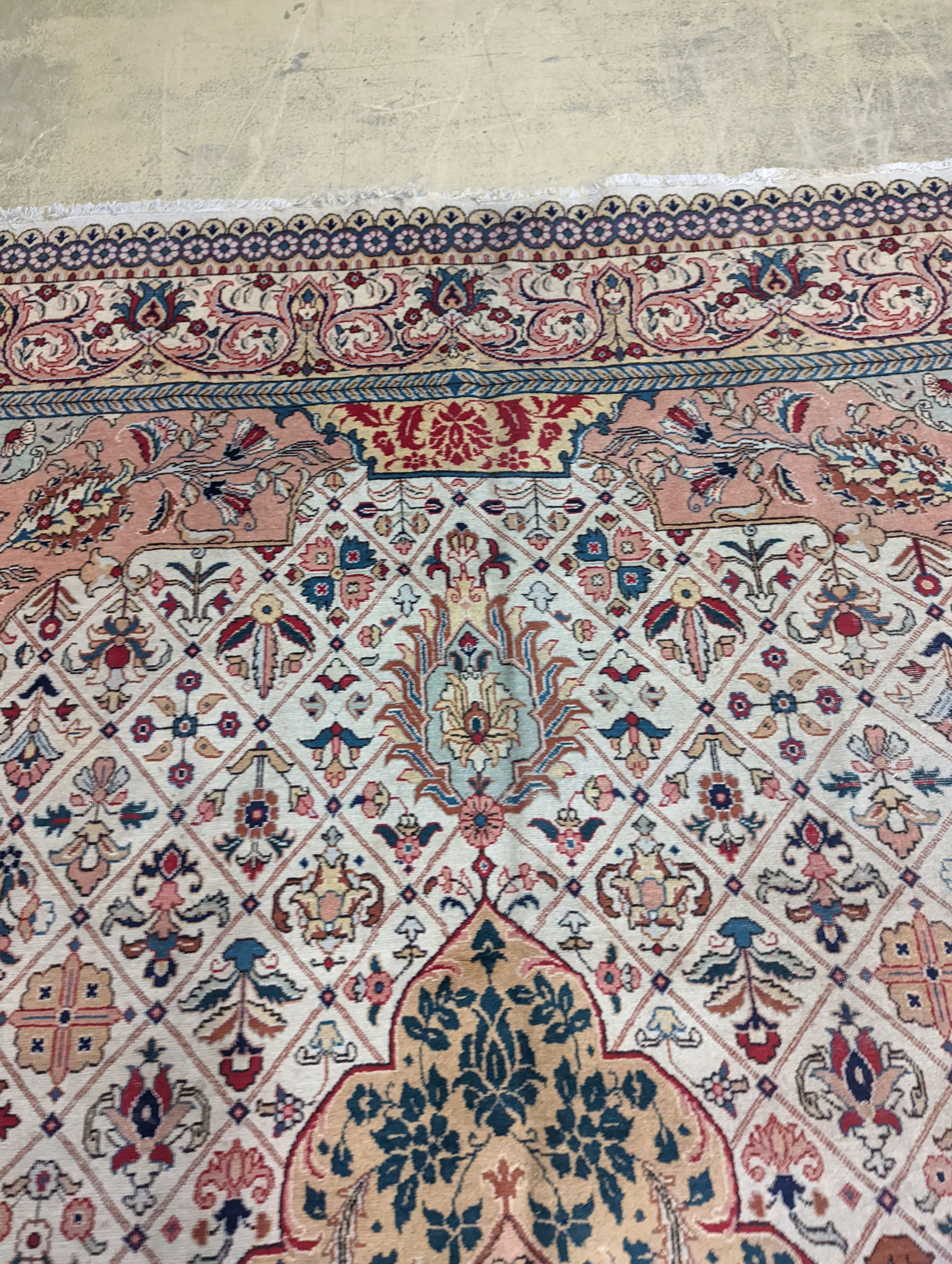 A Tabriz ivory ground carpet, 425 x 306cm